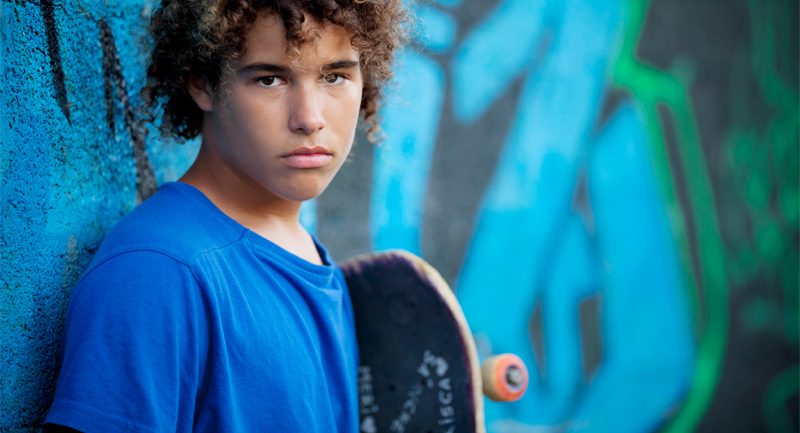 Young male holding skateboard