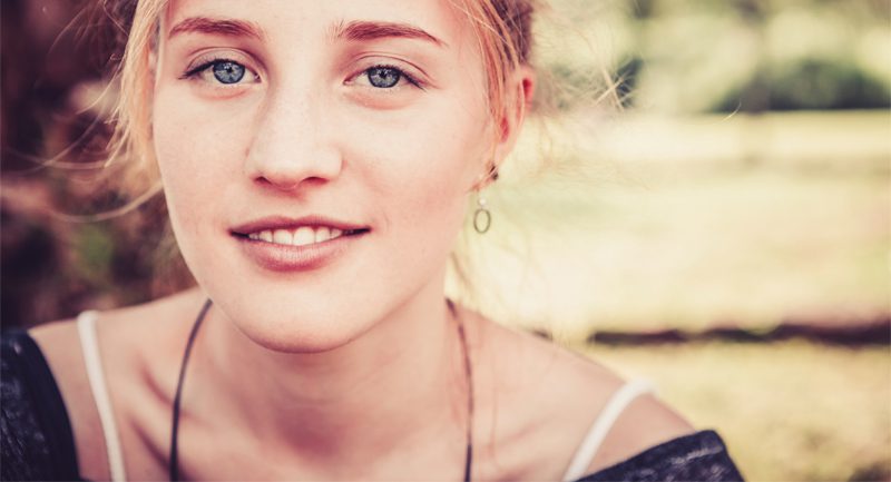 Teenage girl smiling slightly Teenage girl smiling slightly