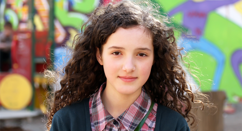 Young dark haired girl wearing checked shirt