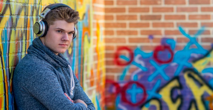 Boy wearing headphones, arms crossed