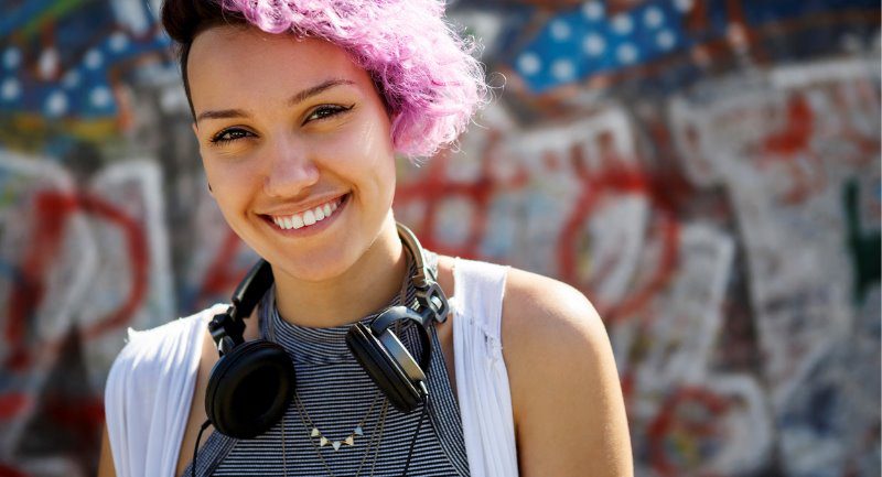 smiling-young-hipster-girl-posing-against-graffiti-wall smiling-young-hipster-girl-posing-against-graffiti-wall