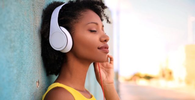 girl wearing yellow top and headphones