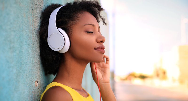 girl wearing yellow top and headphones