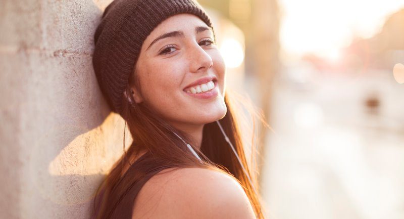 dark haired young lady wearing hat