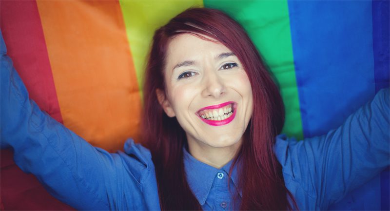 Girl holding rainbow flag