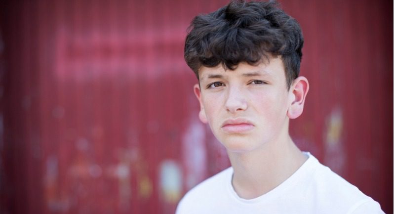 head-and-shoulders-portrait-of-serious-teenage-boy