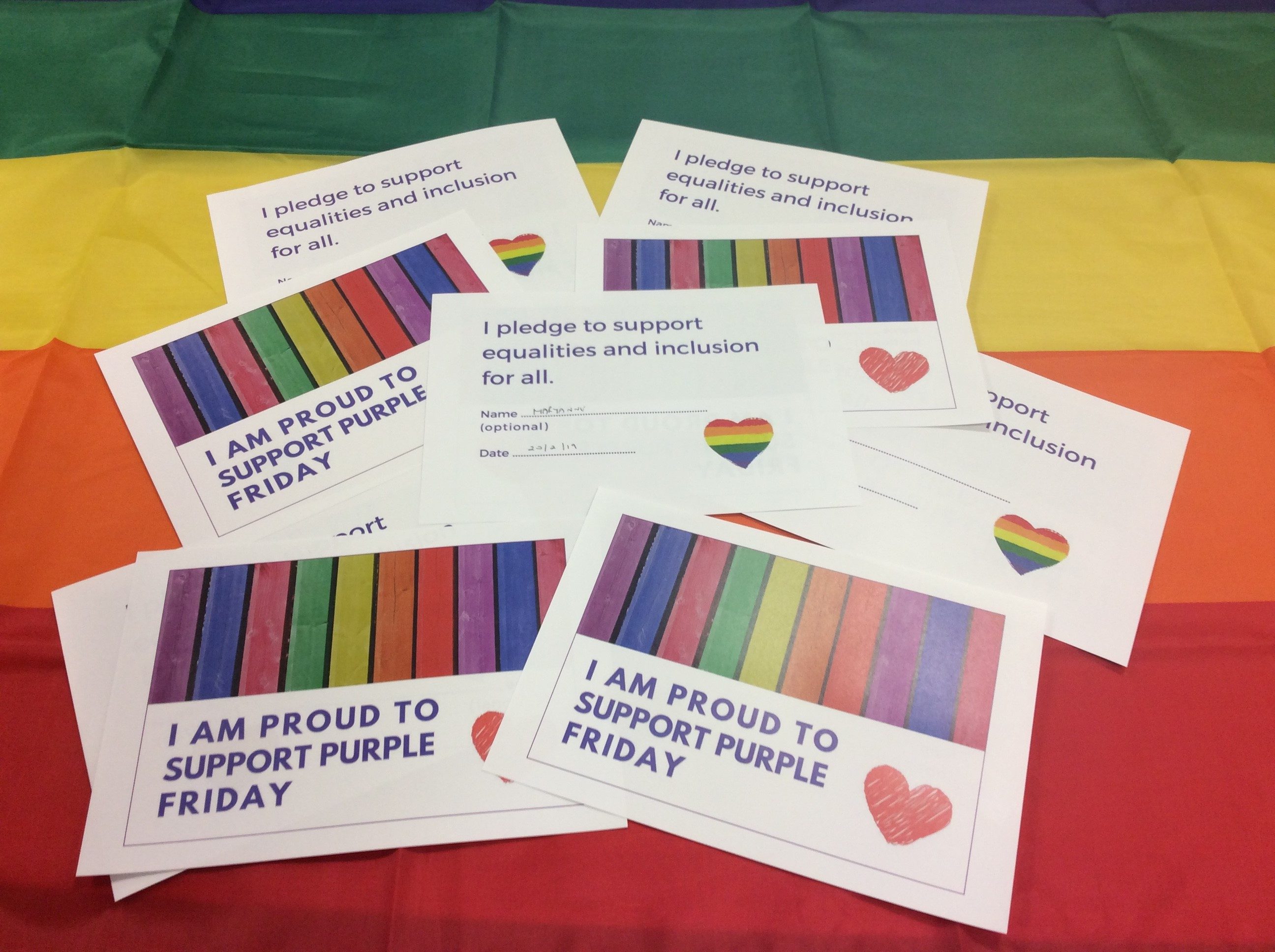 Pledge cards and rainbow flag