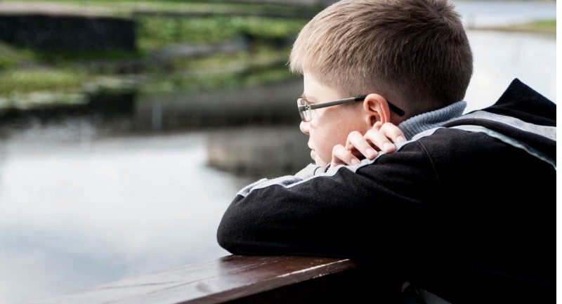 sad-boy-looking-at-the-river