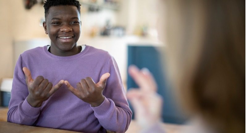 teenage-boy-and-girl-having-conversation-using-sign-language
