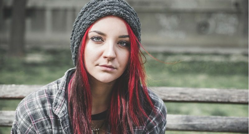 young-beautiful-red-hair-girl-sitting-alone-outdoors