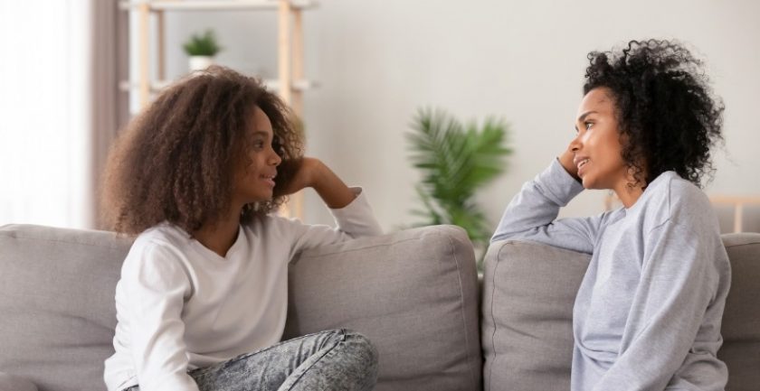 Mother and daughter having a conversation on a couch