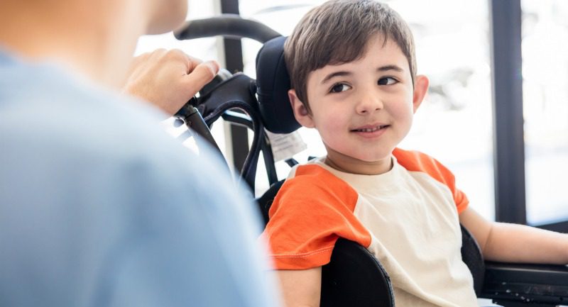 Small young boy in a wheelchair