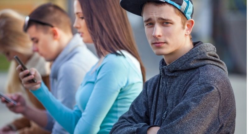 Young man in a baseball cap with a group of teenagers