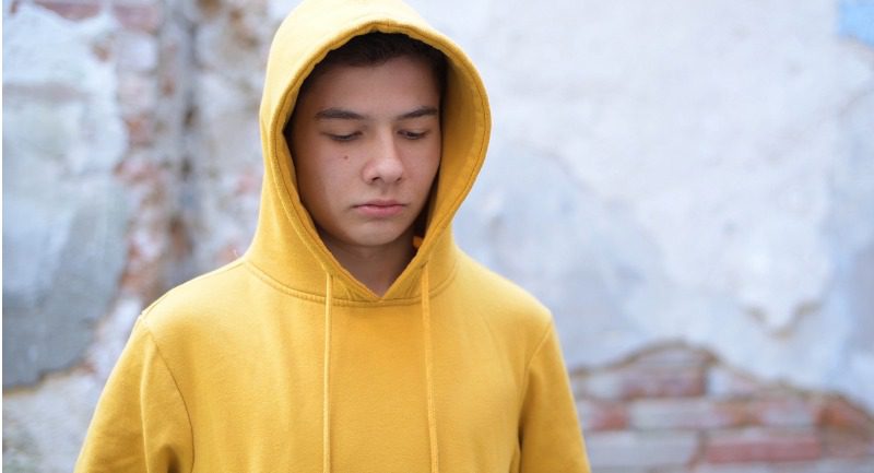 Teenage boy in a yellow hoodie