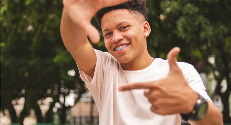 portrait-of-a-guy-doing-frame-with-fingers-looking-at-you-picture