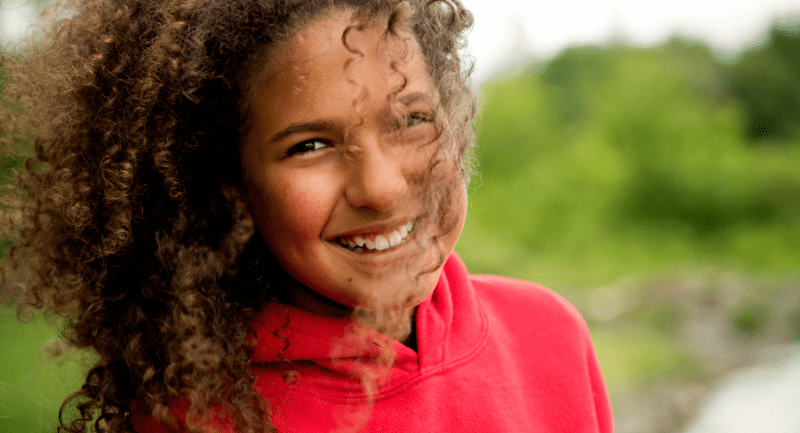 Mixed-race-teenage-girl-portrait-on-riverside