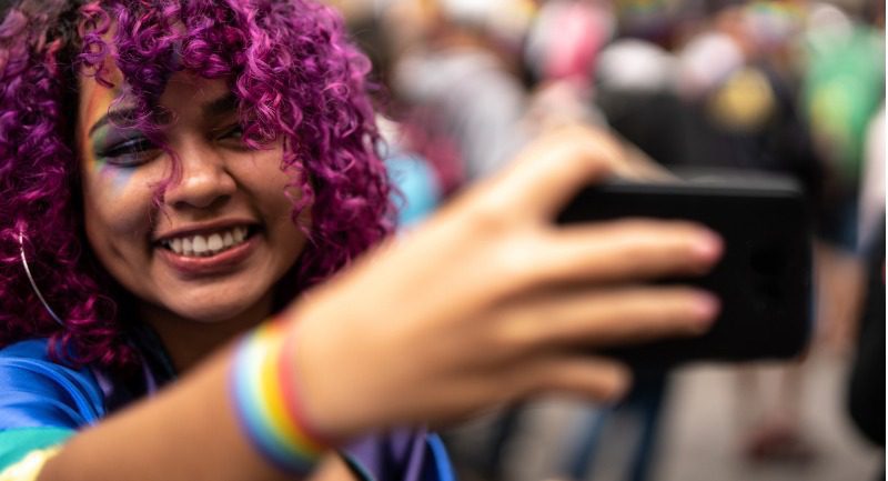 Young woman with pink hair taking a selfie