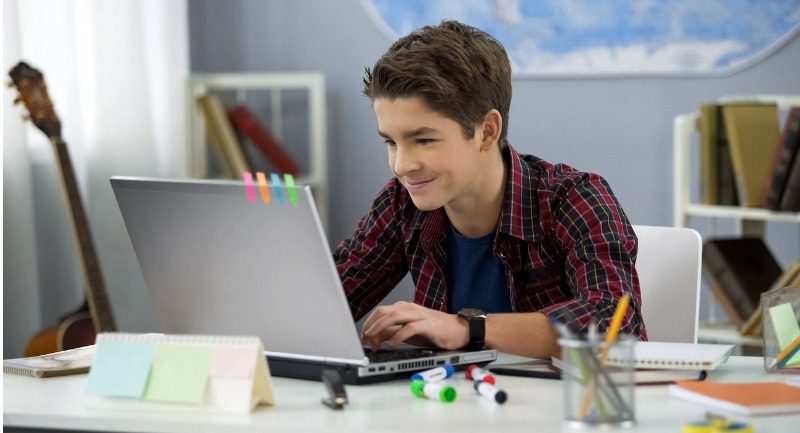 Teenage boy using a laptop