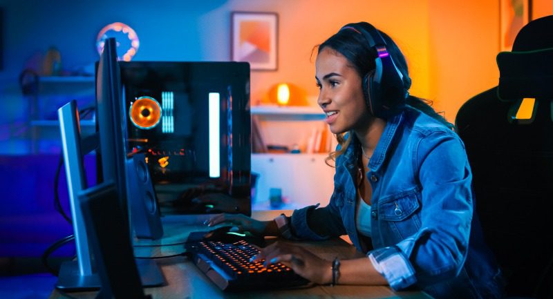Young woman playing on a gamer's PC