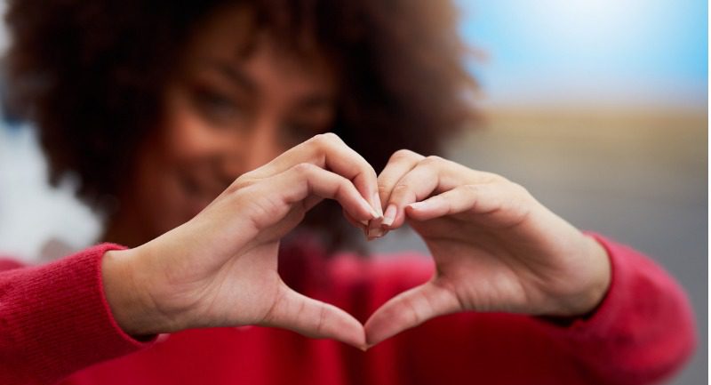 Focus on hands making a heart shape