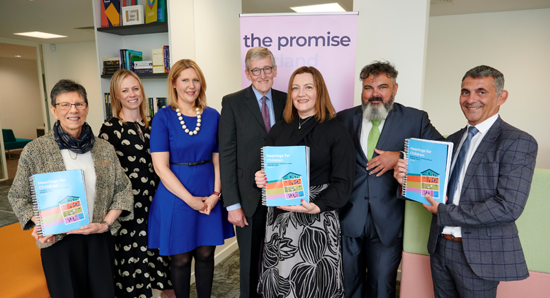 7 adults smiling holding Keeping The Promise leaflets