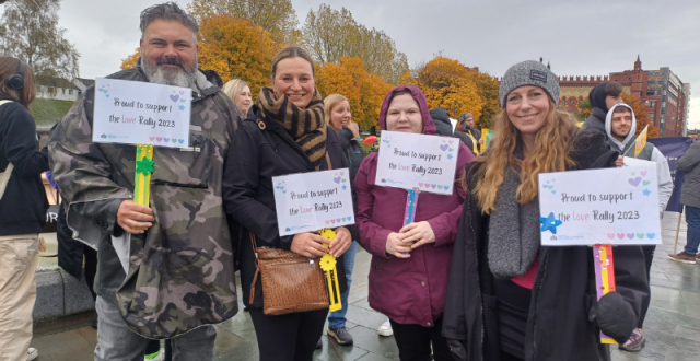 4 members of SCRA staff holing up placards at the 2023 Love Rally in Glasgow