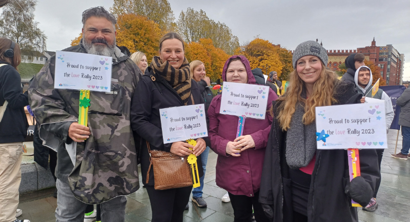 4 members of SCRA staff holing up placards at the 2023 Love Rally in Glasgow 4 members of SCRA staff holing up placards at the 2023 Love Rally in Glasgow