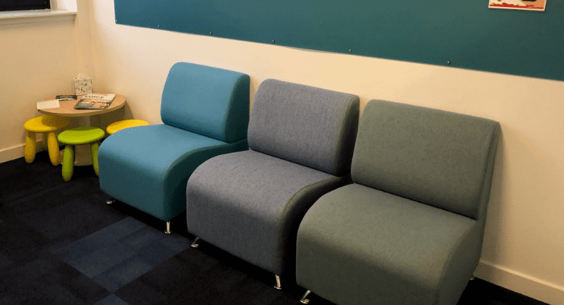 row of multicoloured soft chairs in the Inverness hearing centre