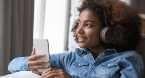 A young girl listening to music on headphones