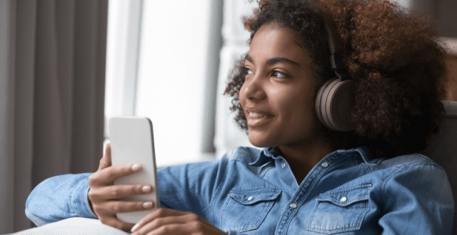A young girl listening to music on headphones