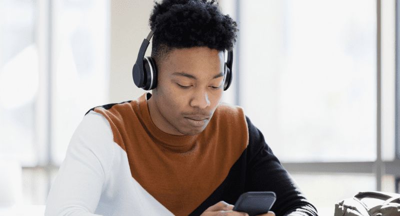 Teen boy distracted by phone