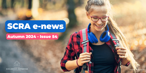 Teenage girl with headphone walking through the autumn trees