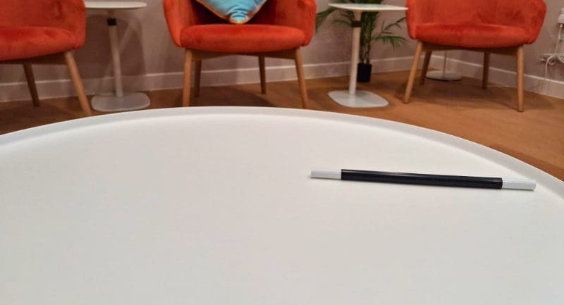 A black and white magic wand on a white table