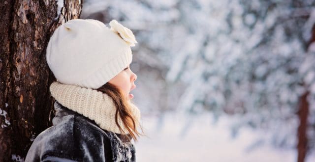 Happy child on a walk in snowy weather