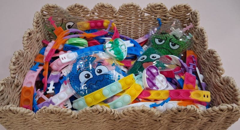 A basket full of multicoloured fidget toys