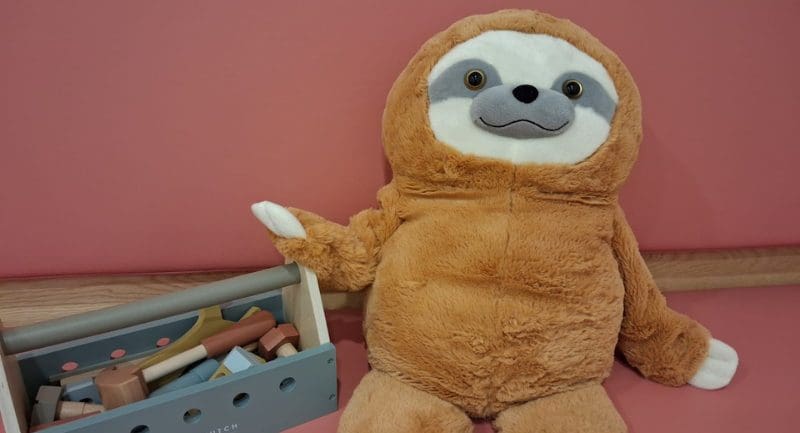 An orange sloth plushy