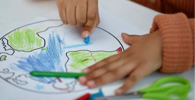 Close up of little girl colouring -planet Earth